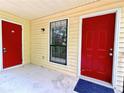 Condo entrance with two red doors and a window, offering curb appeal at 798 Windchase Ln, Stone Mountain, GA 30083