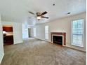 Spacious living room with fireplace, carpet, and neutral walls, creating a welcoming atmosphere at 798 Windchase Ln, Stone Mountain, GA 30083