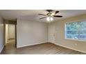 Bright living room with new laminate floors, a ceiling fan, a large window, and a closet at 1581 Wesley Nw Way, Conyers, GA 30012