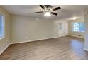 Spacious living area with new laminate floors, ceiling fan, and multiple windows at 1581 Wesley Nw Way, Conyers, GA 30012