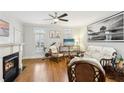 Cozy living area with a fireplace, hardwood floors, and plenty of natural light at 2732 Wander Ln, Alpharetta, GA 30022