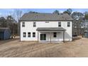 Two-story home with white siding, covered patio, and backyard at 8 Tallulah Trl, Sharpsburg, GA 30277