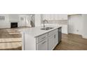Modern kitchen island with quartz countertop and stainless steel appliances at 8 Tallulah Trl, Sharpsburg, GA 30277