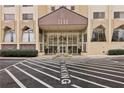 Striking building entrance with covered drop-off, detailed facade, and manicured landscaping offers convenience and curb appeal at 2479 Peachtree Ne Rd # 1012, Atlanta, GA 30305