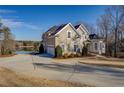 Beautiful two-story home with attached garage, lake view, and manicured lawn at 45 Kinloch Ct, Covington, GA 30014