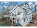 Rear exterior view of home with multi-level deck and lower level entry at 8535 Lynn Dr, Cumming, GA 30041