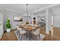 Open concept dining room featuring hardwood floors, modern chandelier, and neutral paint tones at 1125 Blackshear Dr, Decatur, GA 30033