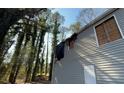 Shows damage on the home's exterior with boarded windows and visible charring at 1193 Meadow Oaks Nw Dr, Acworth, GA 30102
