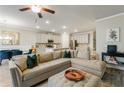 Open-concept living room featuring a large sofa and view of the modern kitchen at 340 Cherryhill Ln, Woodstock, GA 30188