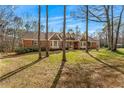 Brick home with mature trees and landscaping at 380 Stone Rd, Mcdonough, GA 30253