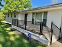 Welcoming front porch with black metal railings leading to the entrance of the white brick home at 4 Crestwood Rd, Cartersville, GA 30121