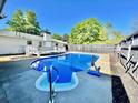 Beautiful in-ground pool in backyard, surrounded by a patio area and a wooden fence at 4 Crestwood Rd, Cartersville, GA 30121