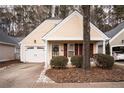 Cute yellow house with white garage door and landscaping at 5055 Kathryn Glen Dr, Acworth, GA 30101