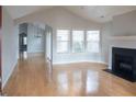 Bright living room with hardwood floors, fireplace, and lots of windows at 5055 Kathryn Glen Dr, Acworth, GA 30101