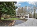 Spacious two-story home boasts a long drive and lovely green lawn at 650 Hunterhill Ct, Roswell, GA 30075