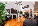 Open concept living room with fireplace, tall ceilings, and a view into the kitchen and dining area at 1045 Paper Creek Dr, Lawrenceville, GA 30046