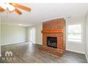 Living room with brick fireplace and sliding glass doors at 20 Oak Wood Ln, Covington, GA 30016