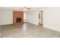 Spacious living room features gray floors, a brick fireplace, and an open doorway to the hall bathroom at 20 Oak Wood Ln, Covington, GA 30016
