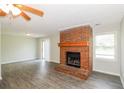 Cozy living area features gray flooring, a brick fireplace with mantle, and a sliding glass door at 20 Oak Wood Ln, Covington, GA 30016