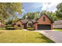 Brick home with stone accents, a landscaped lawn, and a two-car garage at 305 Mogie Ln, Acworth, GA 30102