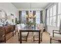 Bright dining room with hardwood floors, neutral decor, glass top dining table and shuttered windows at 5812 Long Park Rd, Cumming, GA 30040