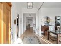 Inviting foyer with hardwood floors, white walls, elegant lighting, and open view to formal living spaces at 5812 Long Park Rd, Cumming, GA 30040