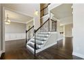 Elegant foyer with hardwood floors and a wrought iron staircase creates a grand entrance at 328 Thistlewood Run, Mcdonough, GA 30252