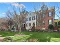 View of brick townhomes featuring landscaped grounds and individual entry staircases at 879 Perennial Dr, Sandy Springs, GA 30328