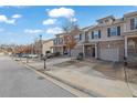 Charming street view of townhomes with garages, well-maintained landscaping, and inviting curb appeal at 2725 Morgan Glen Rd, Buford, GA 30519