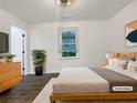 Well-lit main bedroom with a minimalist design, featuring modern decor and hardwood floors at 2704 Ellen Way, Decatur, GA 30032