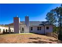 Rear view of the house showcasing a patio and landscaped yard at 40 Eryn Ter, Covington, GA 30014