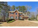 Charming two-story brick home with a well-manicured lawn and attached two car garage at 1150 Cedar Bluff Sw Trl, Lilburn, GA 30047