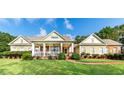 House with a large front porch and manicured lawn at 260 Koller Dr, Powder Springs, GA 30127