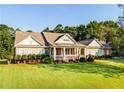 Brick and siding home with a large front porch and lush landscaping at 260 Koller Dr, Powder Springs, GA 30127