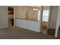 Living room with hardwood and carpeted floors, and a view into the kitchen at 1969 Corners Cir, Lithonia, GA 30058