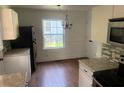 Eat-in kitchen with white cabinets, granite countertops, and hardwood floors at 2351 Johnson Ferry Ne Rd, Chamblee, GA 30341