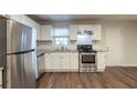 Modern kitchen featuring stainless steel appliances, granite countertops, and white subway tile backsplash at 3881 Bonnie Se Ln, Atlanta, GA 30354