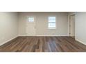 Bright living room showcasing new laminate flooring, fresh paint, and ample natural light at 3881 Bonnie Se Ln, Atlanta, GA 30354