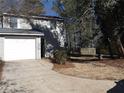 Gray siding two-story house with white garage door at 5112 Central Church Rd, Douglasville, GA 30135