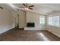 Living room features wood-look floors, painted brick fireplace, and large windows at 2919 Alameda Trl, Decatur, GA 30034