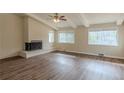 Living room with vaulted ceiling, brick fireplace, and multiple windows at 2919 Alameda Trl, Decatur, GA 30034