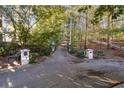 Private gated entrance and long driveway leading to home at 70 Finch Forest Trl, Atlanta, GA 30327