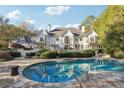 Inviting swimming pool with flagstone patio and lush landscaping at 70 Finch Forest Trl, Atlanta, GA 30327