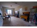 Relaxing living room with plush carpeting, a large window, and vintage furnishings at 1469 Harmony Grove Church Rd, Auburn, GA 30011