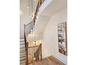 Elegant staircase with wood railings and a unique light fixture at 1211 Stephens Se St, Smyrna, GA 30080