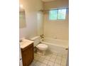 Bathroom with tub, toilet and wood vanity at 158 Scarsdale Dr, Riverdale, GA 30274