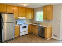 Kitchen with stainless steel appliances and wood cabinets at 158 Scarsdale Dr, Riverdale, GA 30274