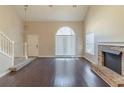 Inviting living room with hardwood floors, high ceilings, fireplace, and lots of natural light from large windows at 1715 Rolling Stone Dr, Lithonia, GA 30058