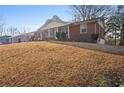 Traditional brick home with a covered porch, trimmed bushes and a well-kept lawn at 6625 Imperial Dr, Morrow, GA 30260