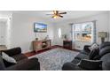 Bright living room featuring hardwood floors, large windows, and comfortable furnishings at 6625 Imperial Dr, Morrow, GA 30260